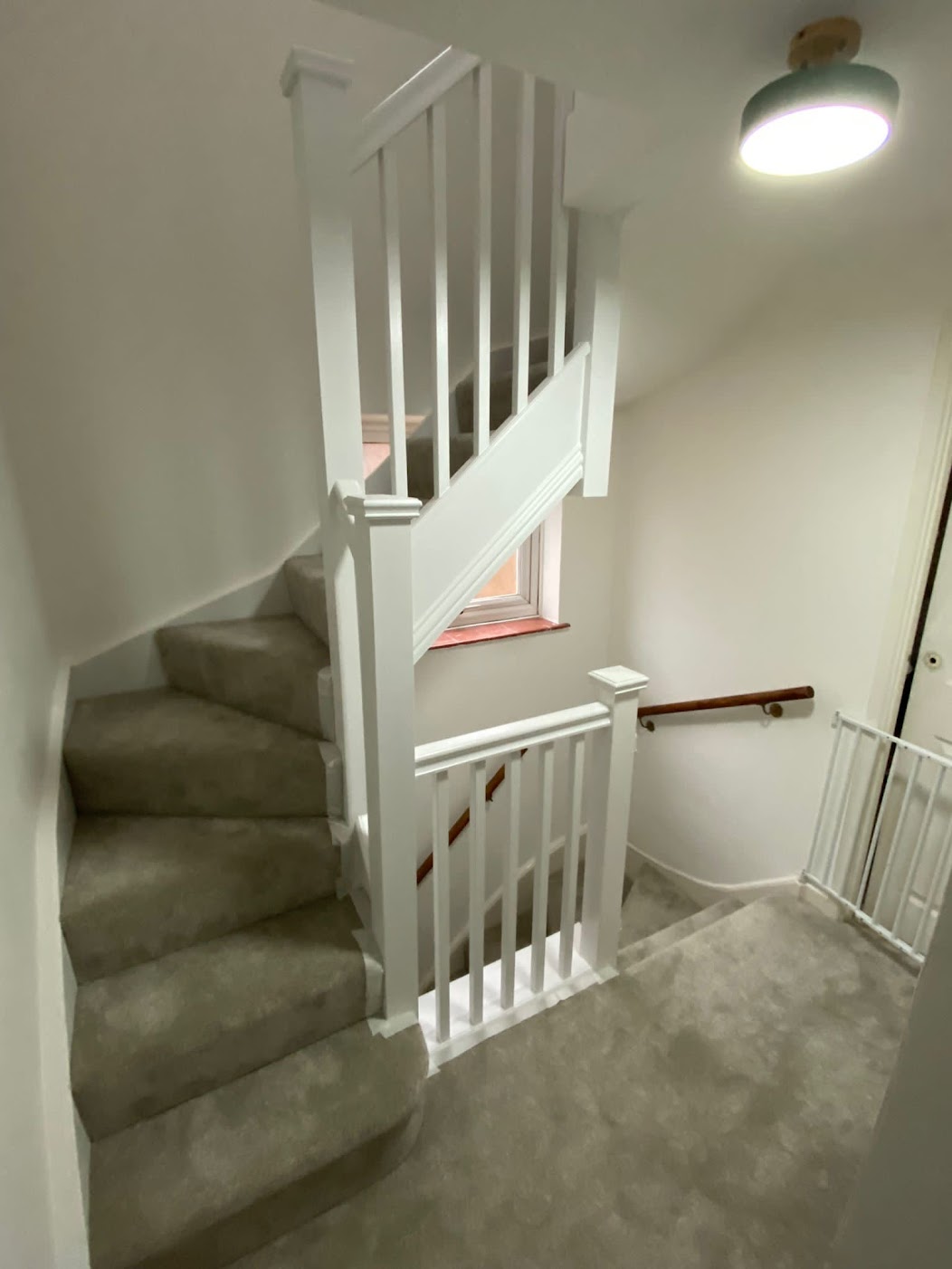 Twisty staircase with newly fitted carpet, access to a converted loft.
